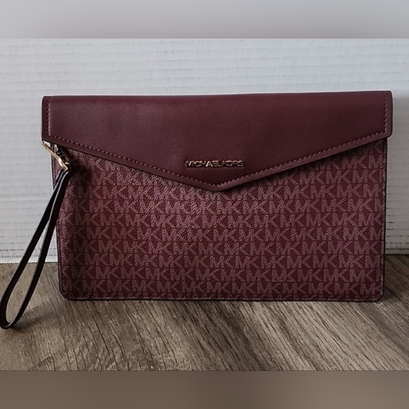 Michael Kors Handbags - $10 START MICHAEL KORS LARGE LEATHER  CLUTCH